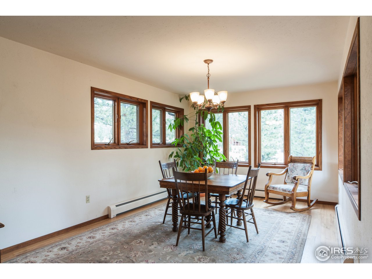 229 Kelly Road East Boulder, CO 80302 - Photo 9 of 25 a view of a dining room with furniture a chandelier and wooden floor