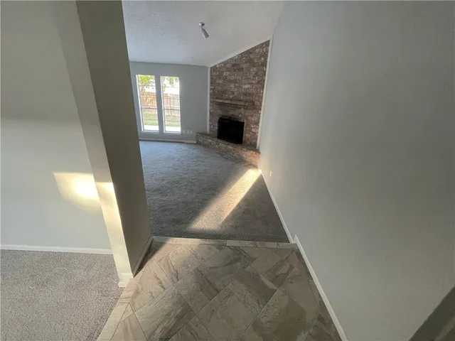 wooden floor in an empty room with a fireplace
