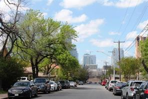 1113 East 3rd Street, Unit A Austin, TX 78702 - Photo 1 of 12 a city street lined with parked cars and buildings