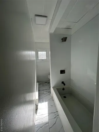 a bathroom with a sink toilet and a mirror