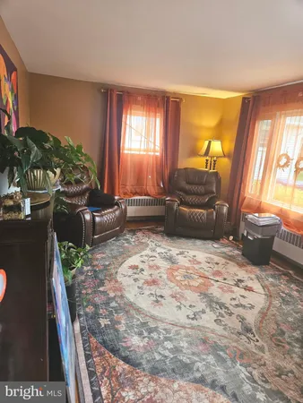 a bedroom with furniture and a large window