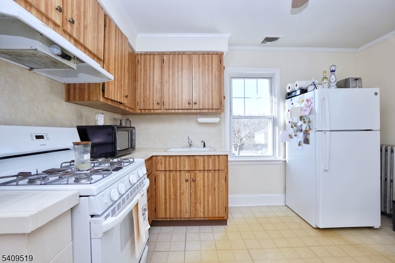 103 Orchard Street, Unit 2 Summit, NJ 07901 - Photo 12 of 17 a kitchen with stainless steel appliances granite countertop a refrigerator sink and cabinets