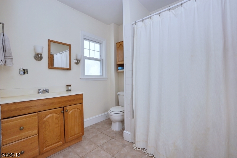 103 Orchard Street, Unit 2 Summit, NJ 07901 - Photo 13 of 17 a bathroom with a sink a toilet and a mirror