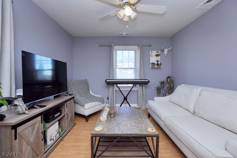 103 Orchard Street, Unit 2 Summit, NJ 07901 - Photo 3 of 17 a living room with furniture and a flat screen tv