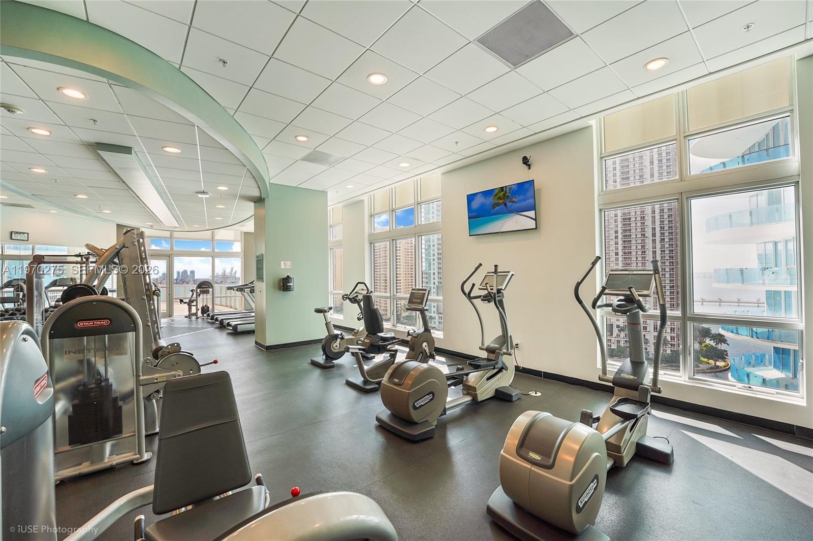 300 South Biscayne Boulevard, Unit T2602 Miami, FL 33131 - Photo 15 of 17 a room with gym equipment and a large window