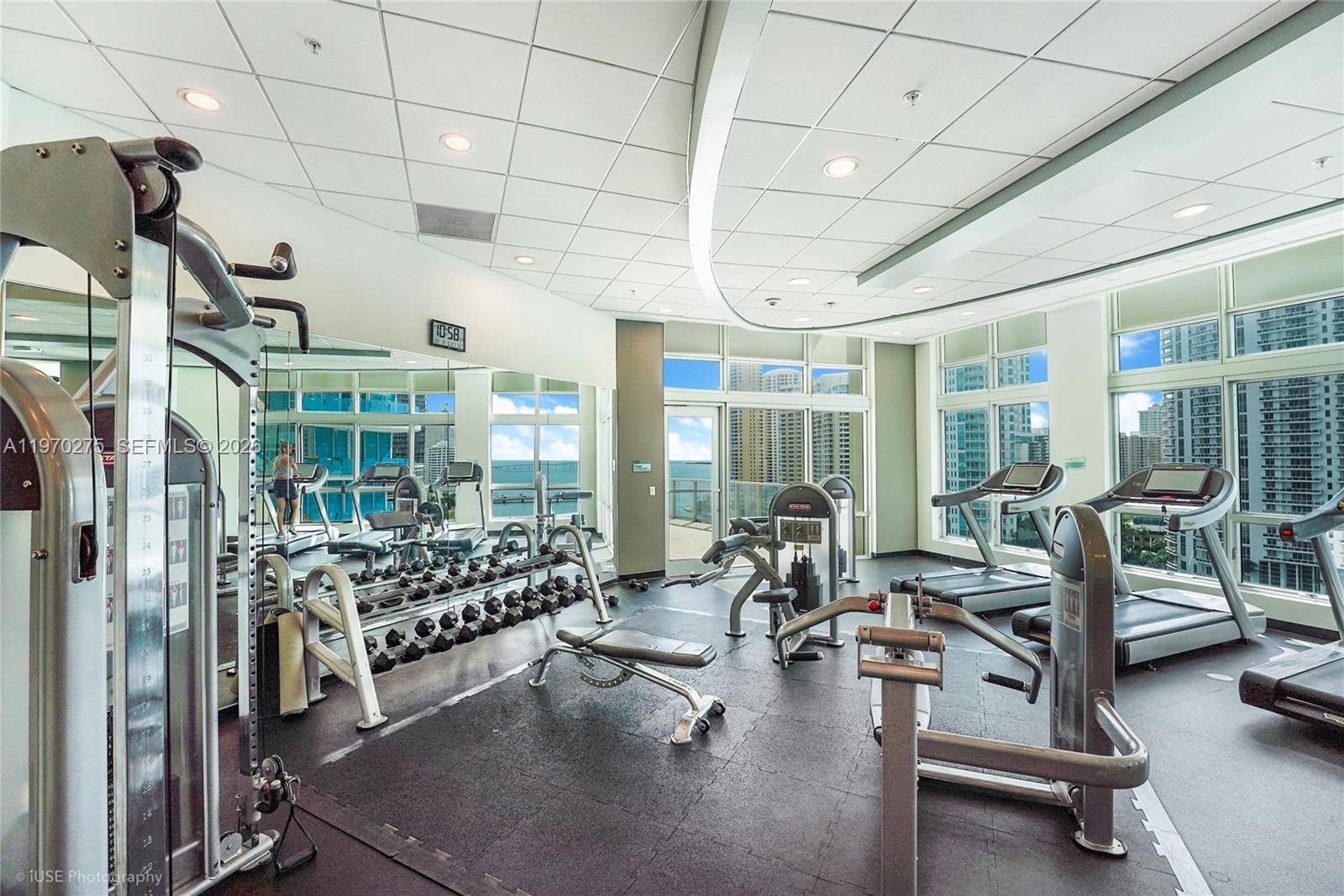 300 South Biscayne Boulevard, Unit T2602 Miami, FL 33131 - Photo 16 of 17 a room with gym equipment and large windows