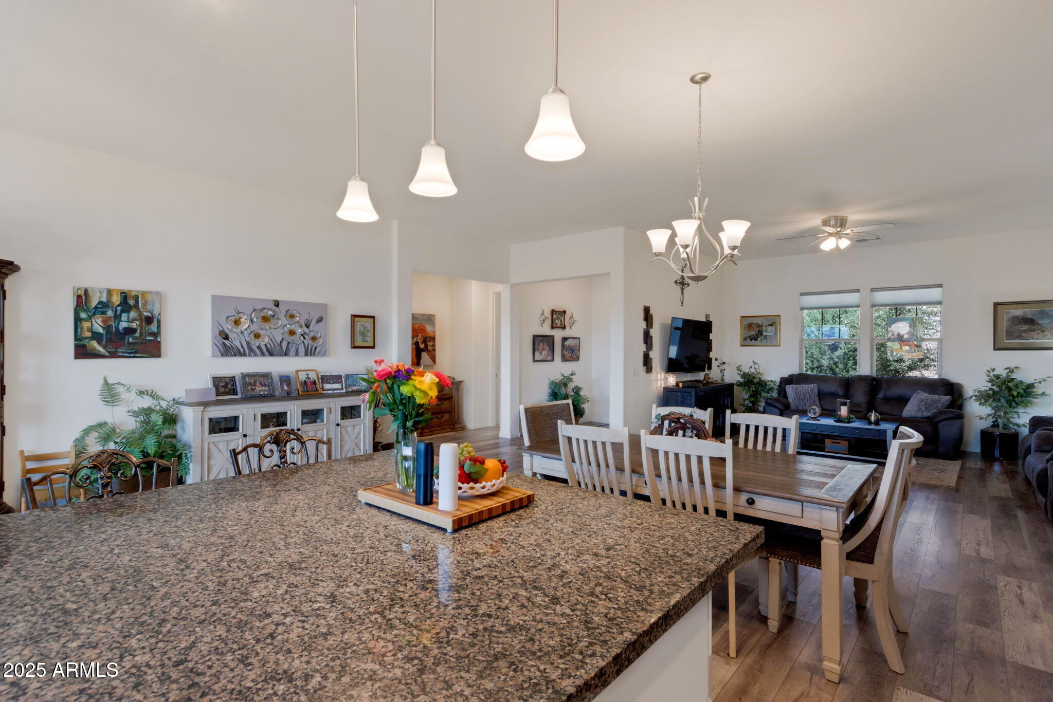 6025 North Hanover Court Rimrock, AZ 86335 - Photo 11 of 30 a living room with furniture a chandelier a fireplace and a dining table with wooden floor