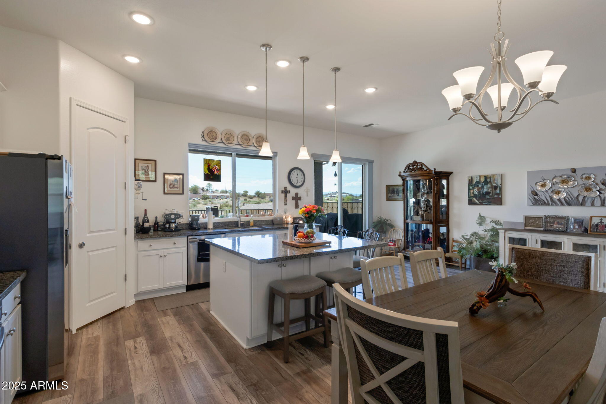 6025 North Hanover Court Rimrock, AZ 86335 - Photo 9 of 30 a kitchen with kitchen island stainless steel appliances a dining table and chairs