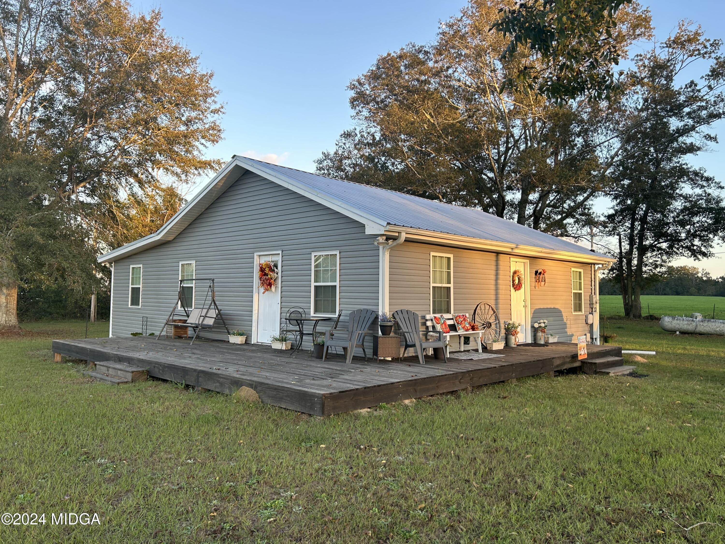 11 Pope Road Roberta, GA 31078 - Photo 1 of 15 a front view of house with yard seating and patio