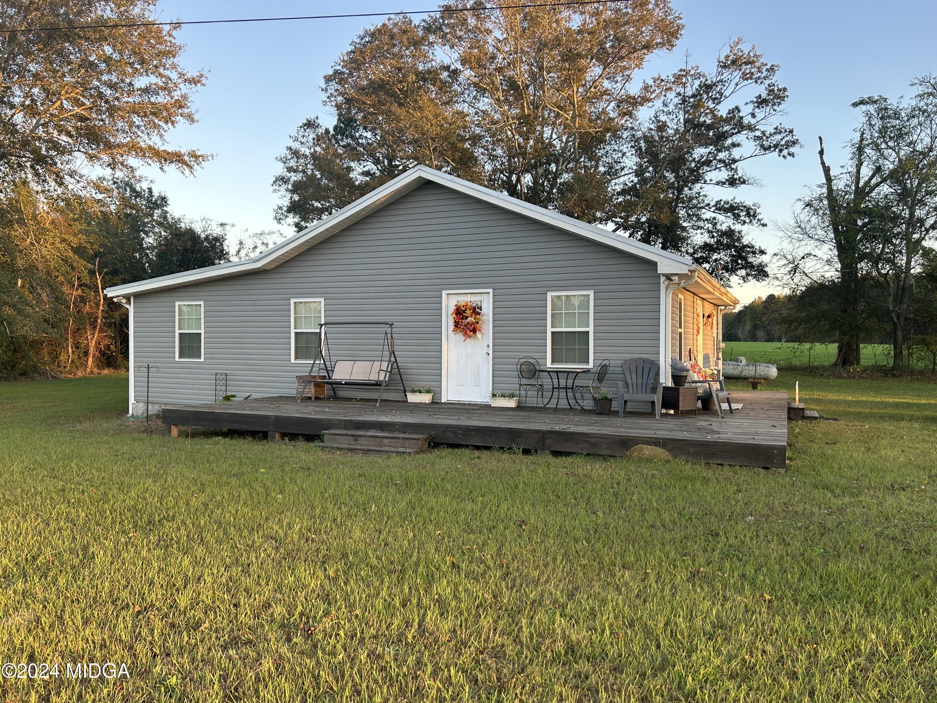 11 Pope Road Roberta, GA 31078 - Photo 15 of 15 a view of a house with swimming pool and a garden