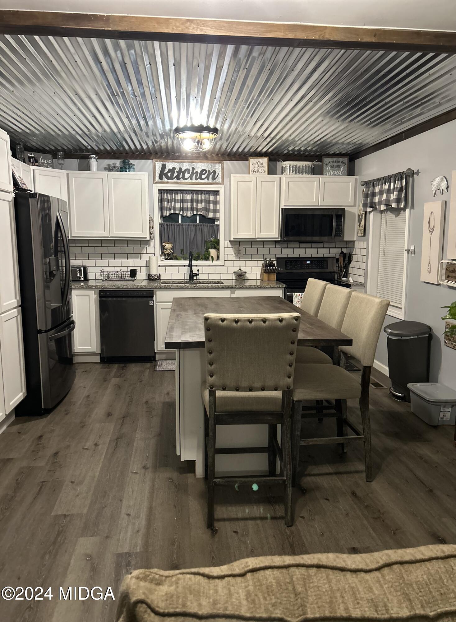 11 Pope Road Roberta, GA 31078 - Photo 6 of 15 a kitchen with stainless steel appliances granite countertop a refrigerator a stove a sink dishwasher and a microwave