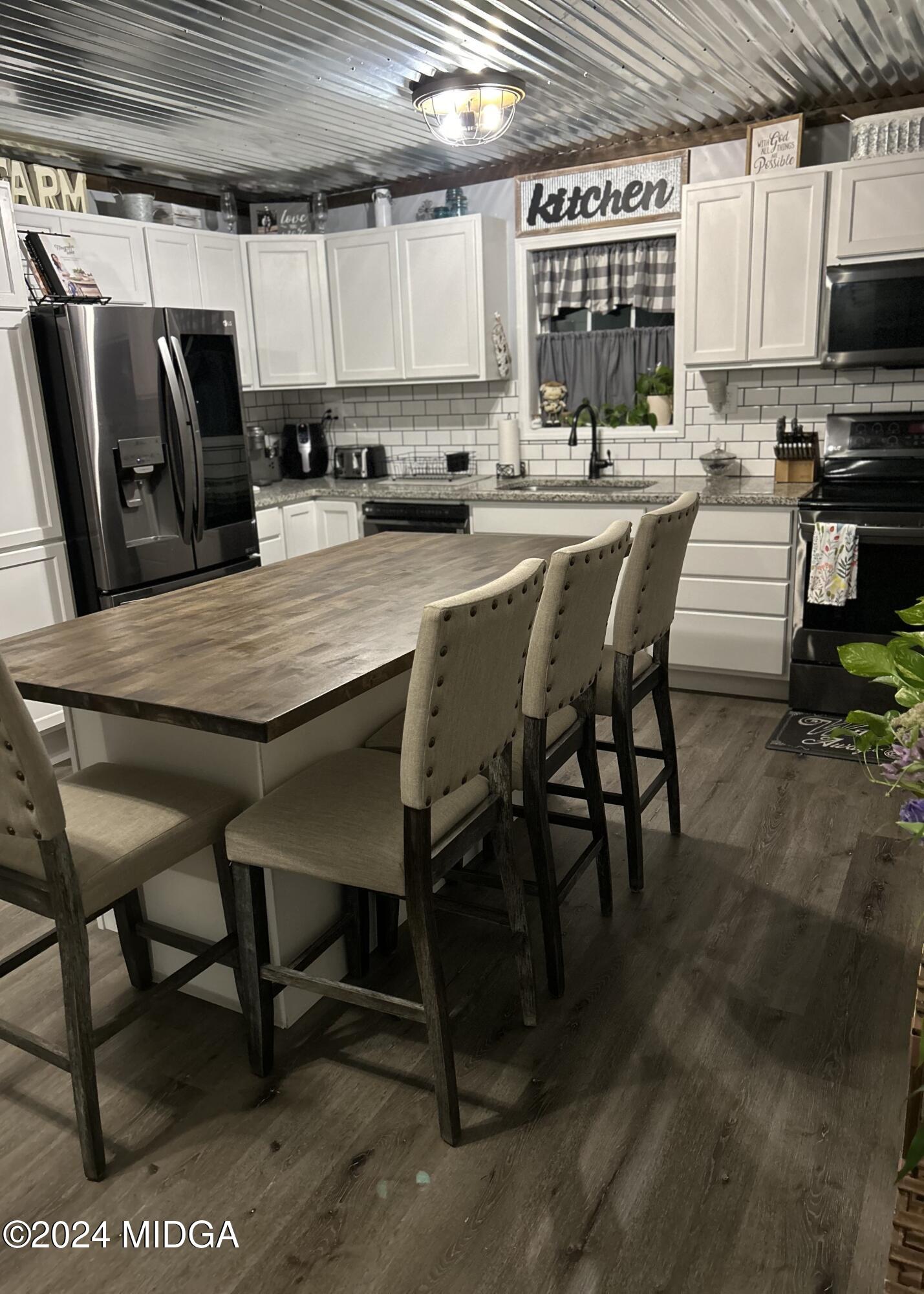 11 Pope Road Roberta, GA 31078 - Photo 8 of 15 a kitchen with stainless steel appliances dining table chairs and a window