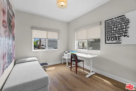 a bedroom with bed and a window