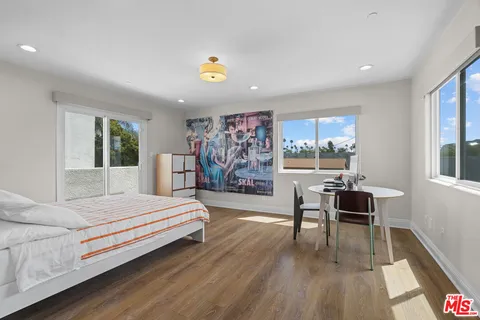 a bedroom with a bed and a large window