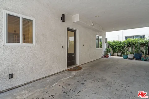 a view of a hallway with potted plants