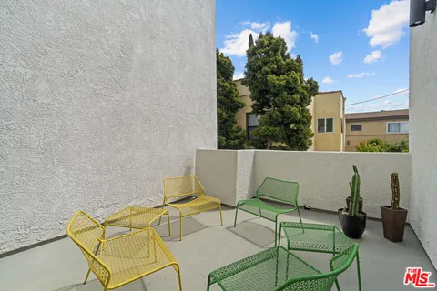 a view of a chairs and table in a terrace