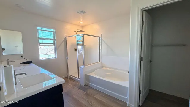 a bathroom with a tub sink and mirror
