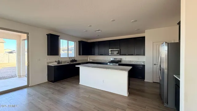 a kitchen with a sink and a refrigerator