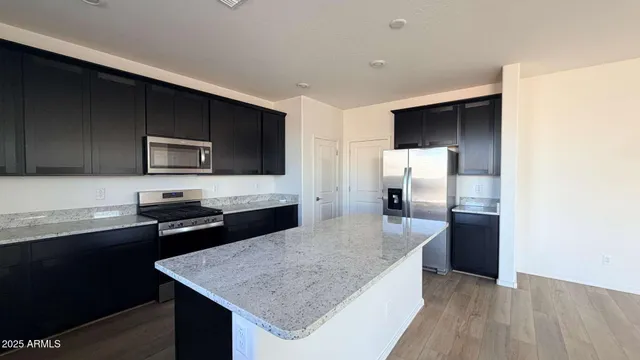 a kitchen with a sink refrigerator and microwave