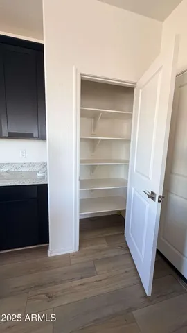 a room with a hardwood floor and a fireplace