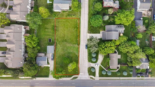 an aerial view of a house with garden space and plants