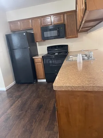 a kitchen with stainless steel appliances granite countertop a refrigerator and a stove