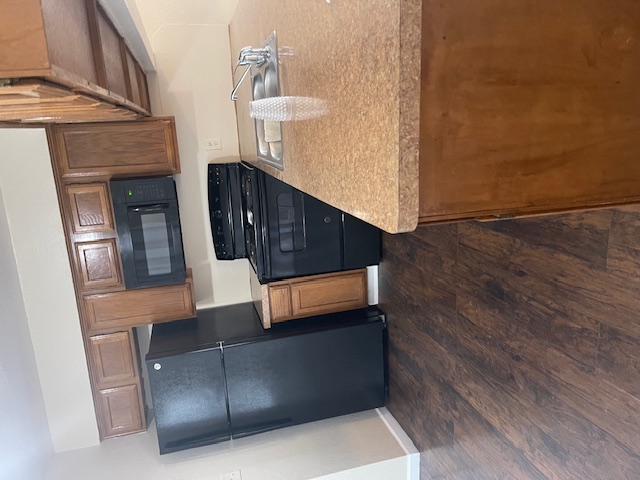 908 Guadalupe Street Lockhart, TX 78644 - Photo 3 of 8 a kitchen with stainless steel appliances granite countertop a refrigerator and a stove