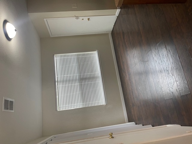 908 Guadalupe Street Lockhart, TX 78644 - Photo 4 of 8 an empty room with wooden floor and windows