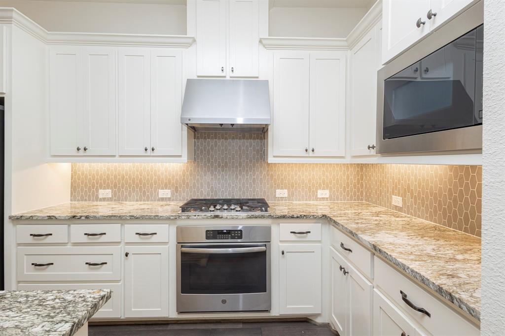 6337 Saddlebrook Way Irving, TX 75039 - Photo 12 of 40 a kitchen with granite countertop a stove and a sink