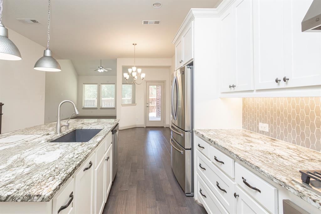 6337 Saddlebrook Way Irving, TX 75039 - Photo 13 of 40 a kitchen with granite countertop a sink stove and cabinets