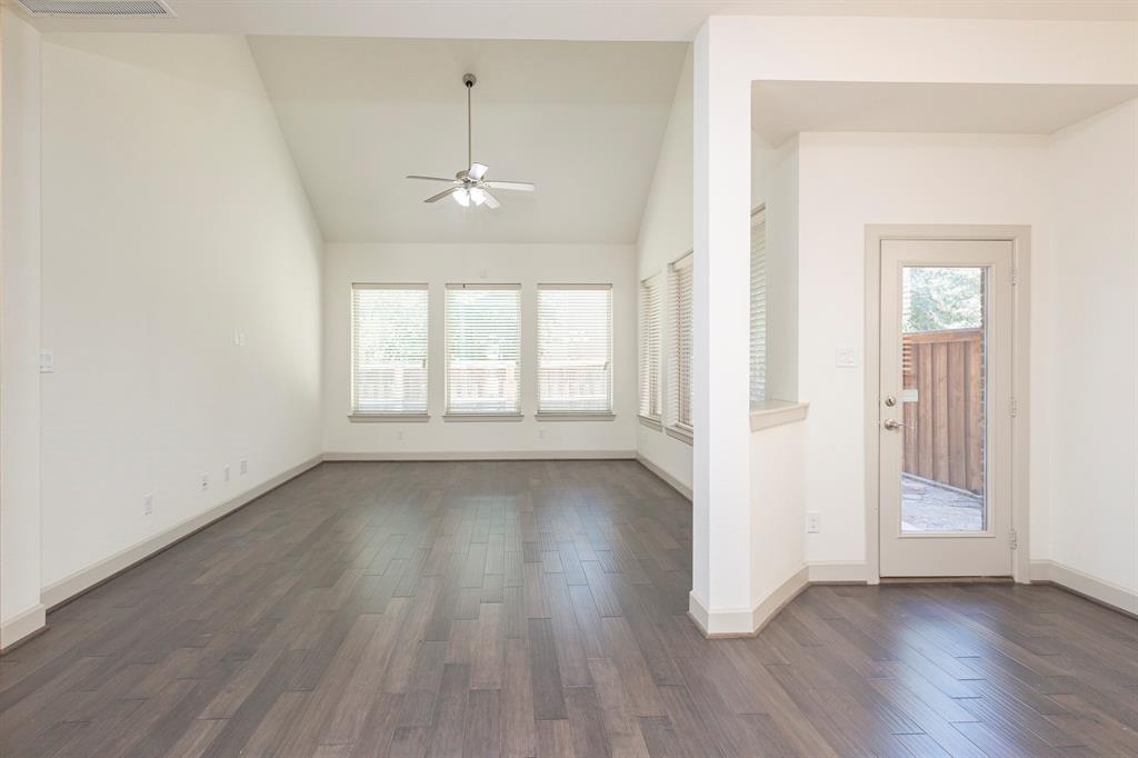 6337 Saddlebrook Way Irving, TX 75039 - Photo 15 of 40 an empty room with wooden floor chandelier and windows