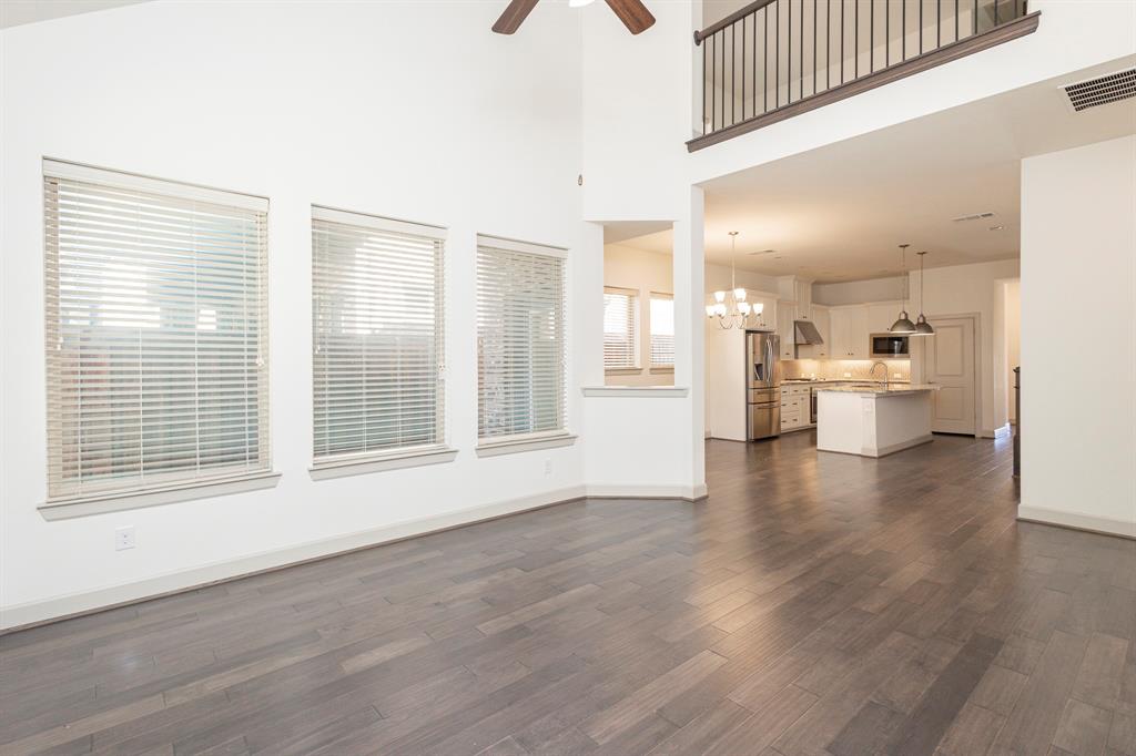 6337 Saddlebrook Way Irving, TX 75039 - Photo 17 of 40 a view of an empty room with a window and wooden floor