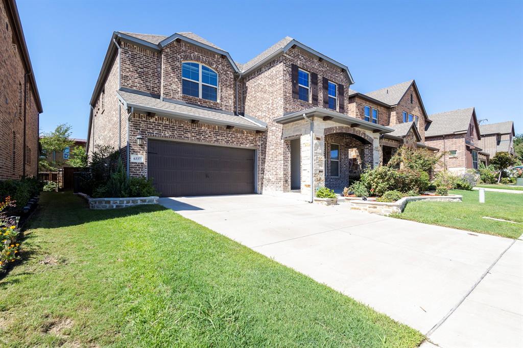 6337 Saddlebrook Way Irving, TX 75039 - Photo 2 of 40 a front view of a house with a yard and garage