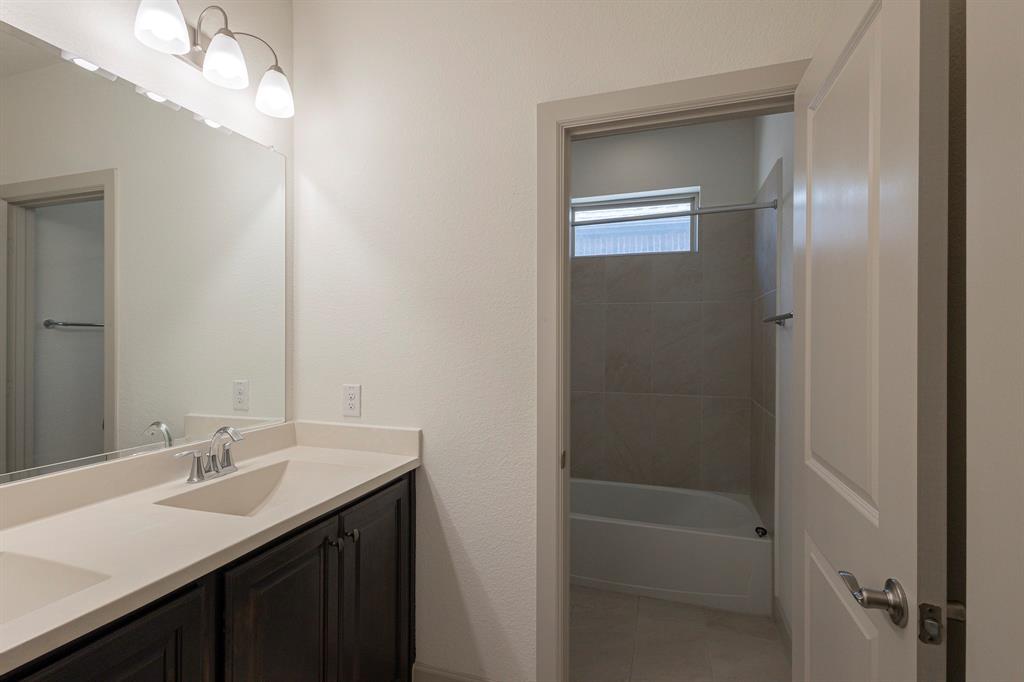 6337 Saddlebrook Way Irving, TX 75039 - Photo 35 of 40 a bathroom with a sink a shower and a mirror