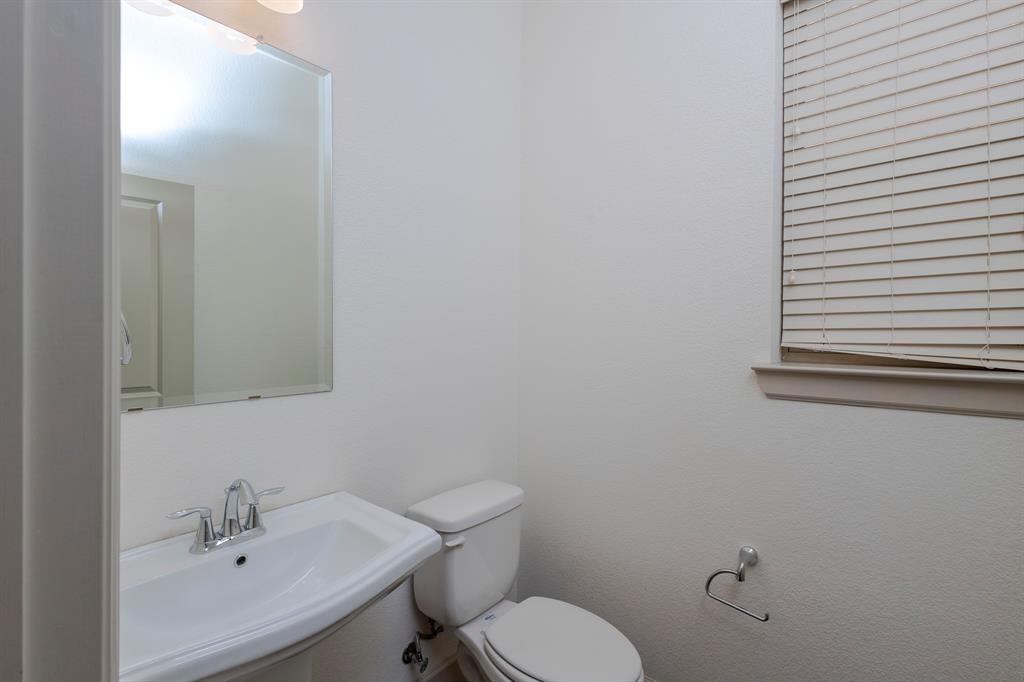 6337 Saddlebrook Way Irving, TX 75039 - Photo 8 of 40 a bathroom with a sink mirror and toilet