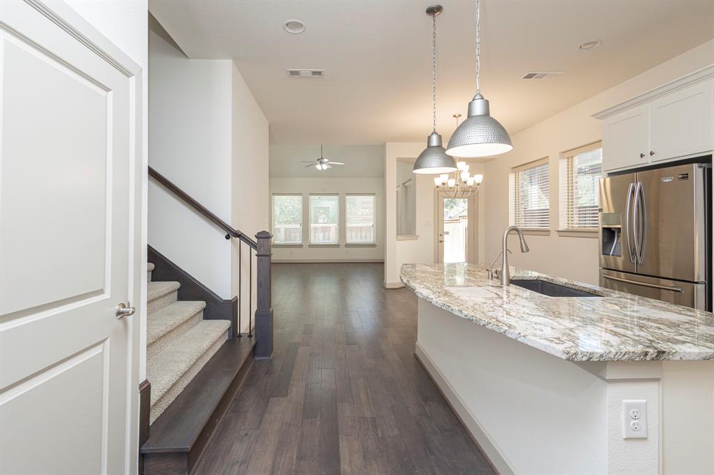 6337 Saddlebrook Way Irving, TX 75039 - Photo 9 of 40 a kitchen with stainless steel appliances granite countertop a refrigerator a sink dishwasher a oven and a dining table with wooden floor