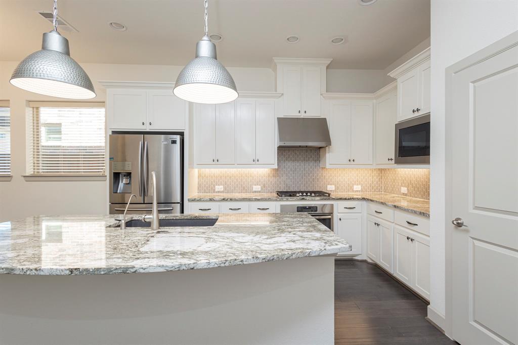 6337 Saddlebrook Way Irving, TX 75039 - Photo 10 of 40 a kitchen with granite countertop a sink stainless steel appliances and cabinets