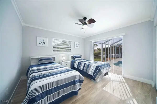 a bedroom with two beds and a large window