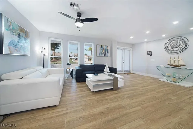 a living room with furniture and a wooden floor