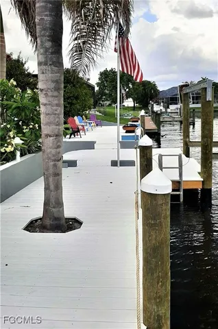 a view of a patio with table and chairs potted plants with wooden floor