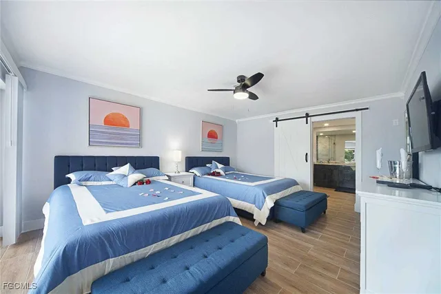 a bedroom with furniture and a wooden floor