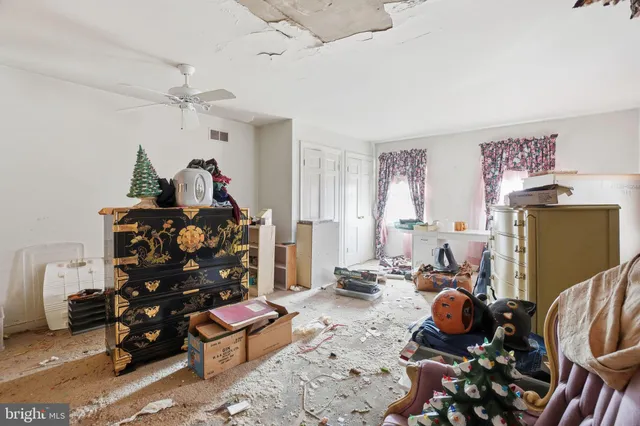 a bedroom with furniture and a fan