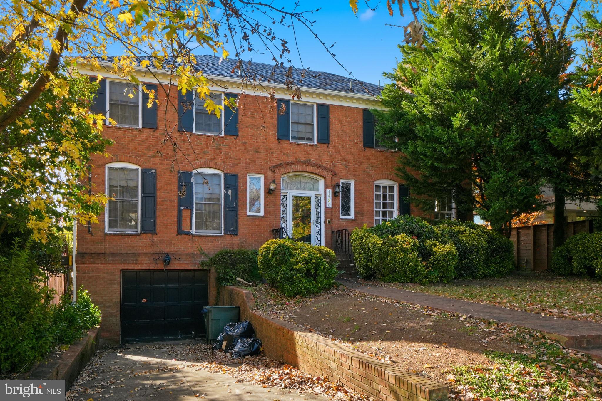 1430 Foxhall Road Northwest Washington, DC 20007 - Photo 2 of 53 a front view of a house with a garden