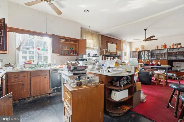 a room with a table chairs stove and cabinets