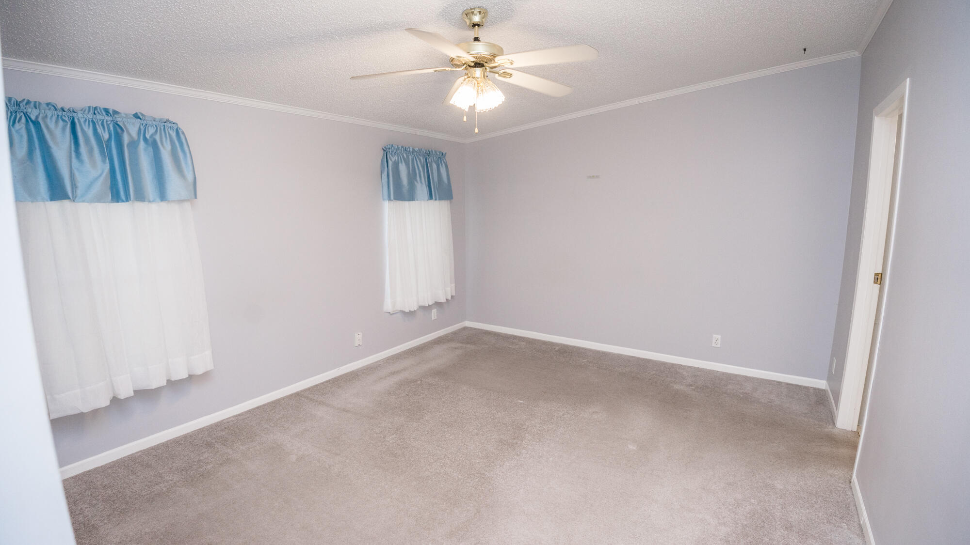 125 Red Eye Road DeFuniak Springs, FL 32433 - Photo 12 of 50 an empty room with windows and fan