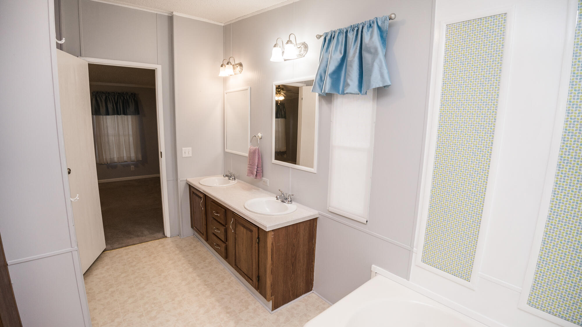 125 Red Eye Road DeFuniak Springs, FL 32433 - Photo 16 of 50 a bathroom with a sink and mirror