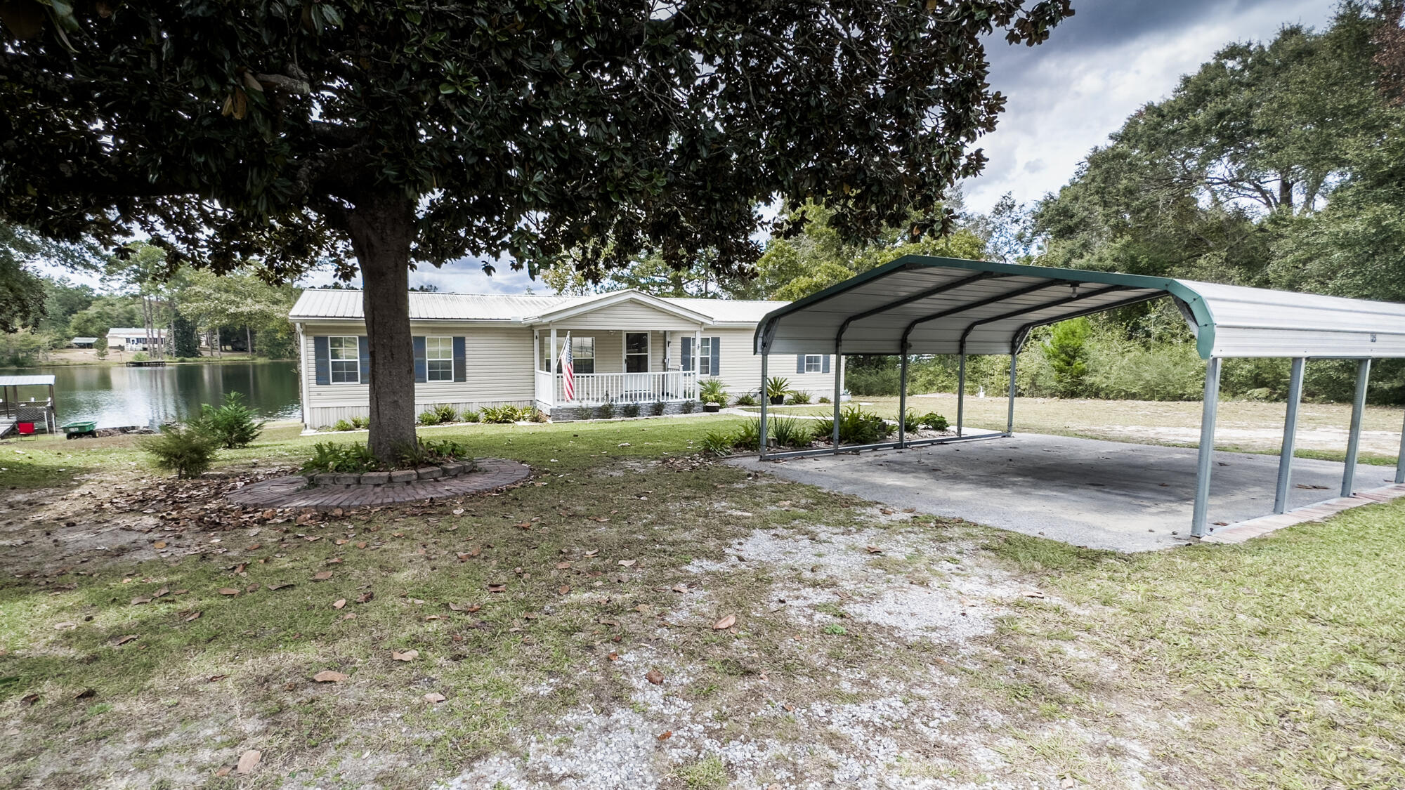 125 Red Eye Road DeFuniak Springs, FL 32433 - Photo 30 of 50 a patio with a yard table and chairs