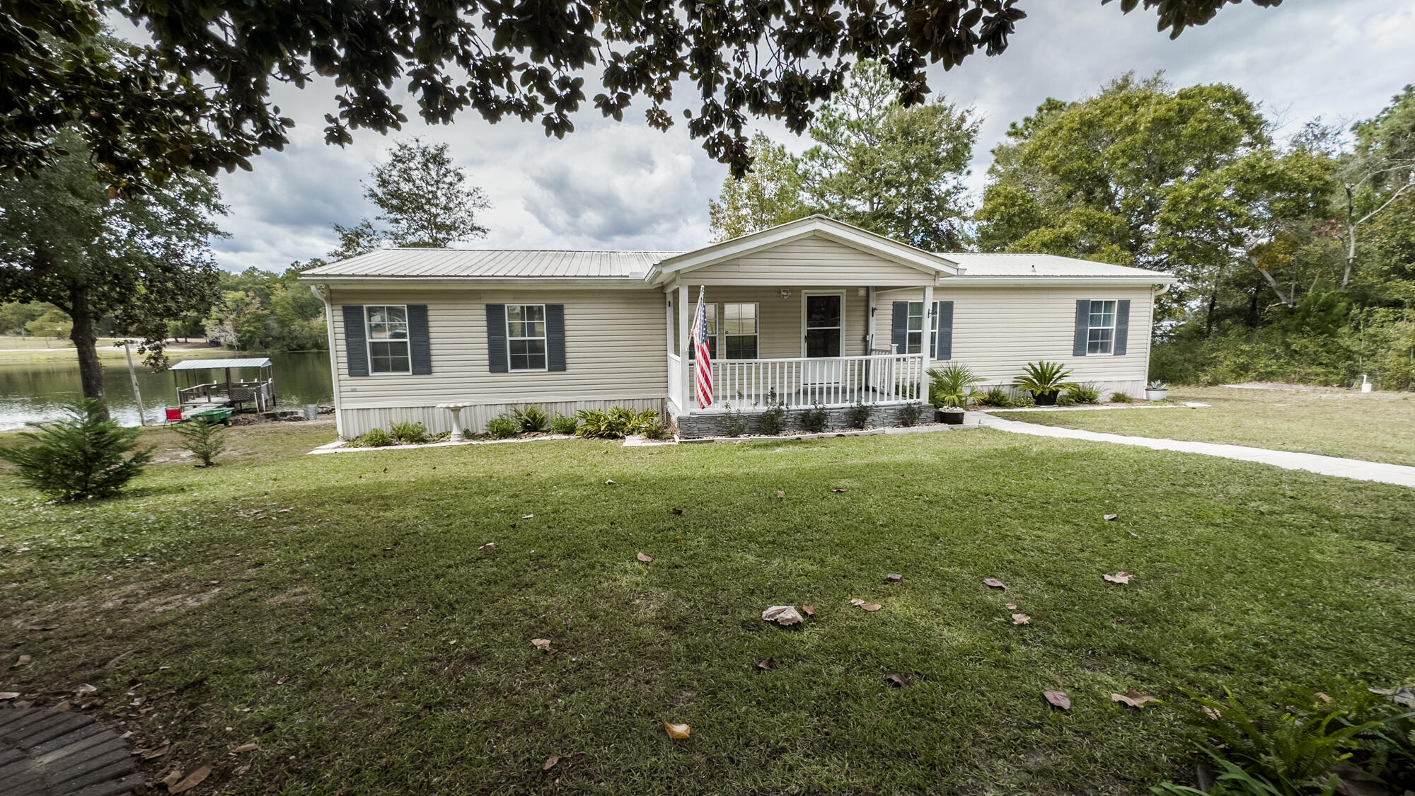 125 Red Eye Road DeFuniak Springs, FL 32433 - Photo 32 of 50 a front view of a house with garden