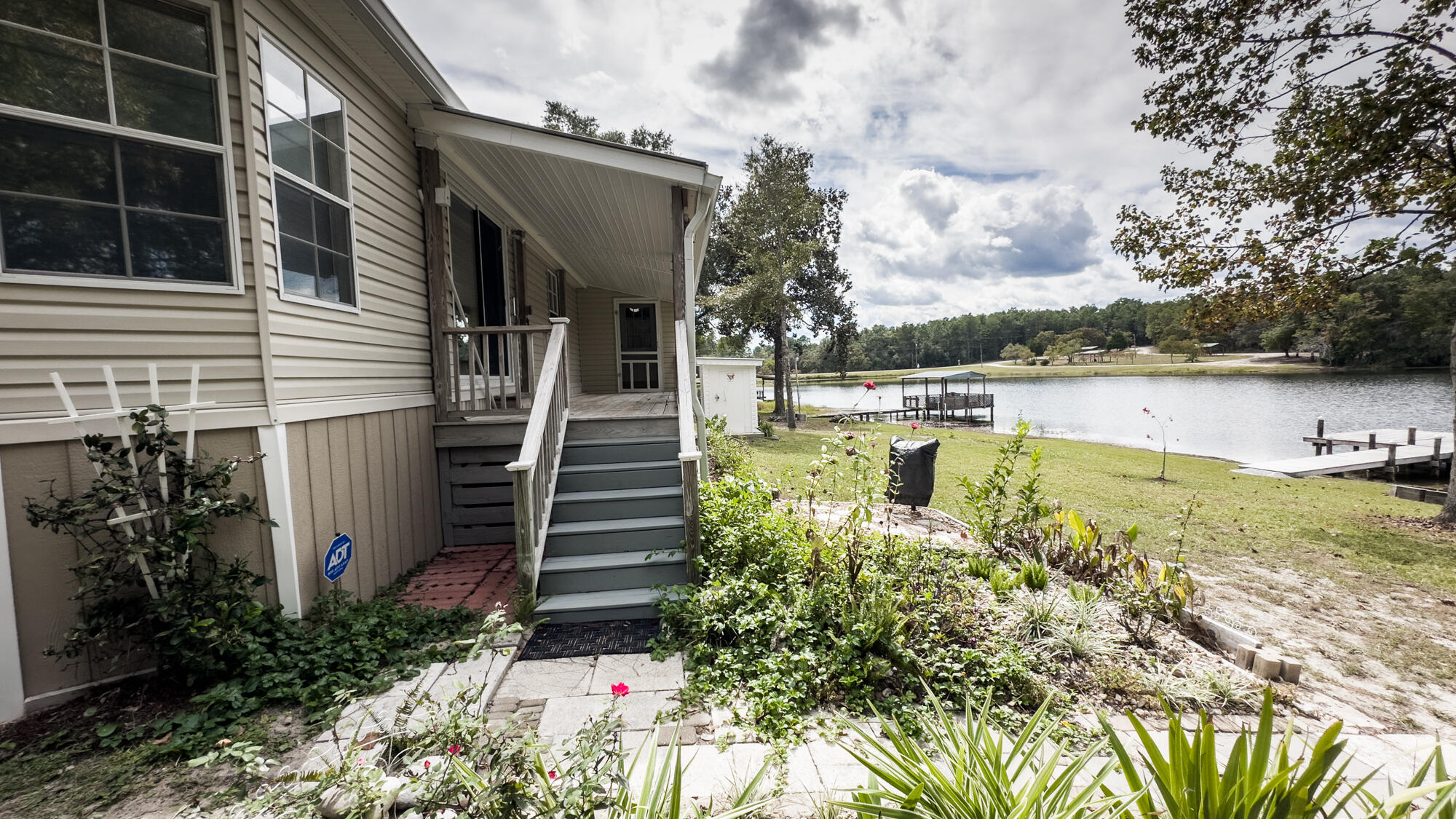 125 Red Eye Road DeFuniak Springs, FL 32433 - Photo 42 of 50 a view of a house with pool garden and lake view