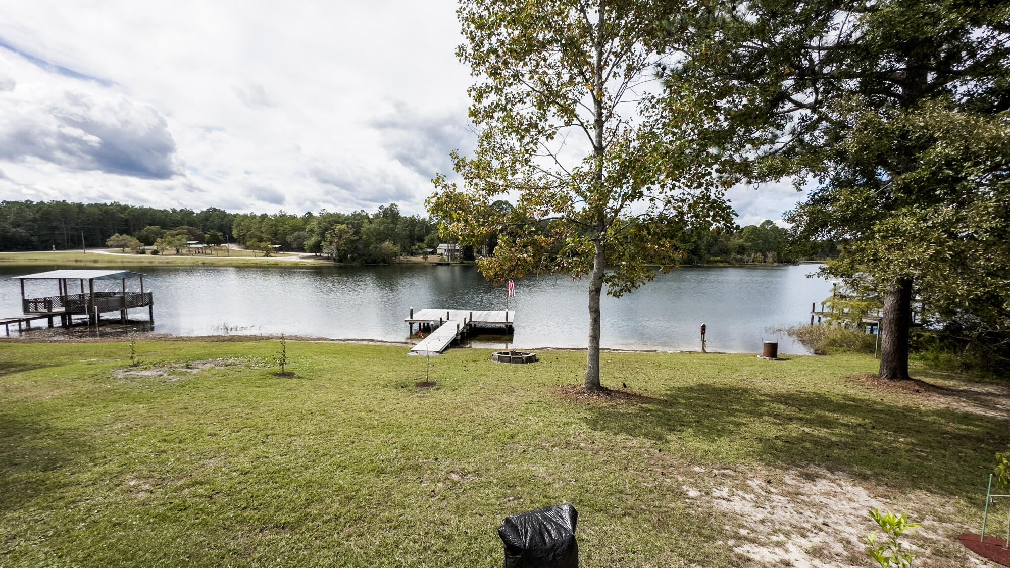 125 Red Eye Road DeFuniak Springs, FL 32433 - Photo 44 of 50 a backyard of a house with lots of green space and lake view